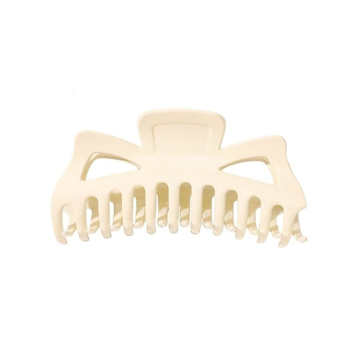 The SOHO Astrid Hair Claw - White by SOHO is a large plastic hair clip featuring wide, curved teeth and two triangular cutouts near the top—ideal for securing thick hair.