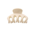 Die SOHO Esta Hair Claw – White von SOHO ist eine kleine, cremefarbene Kunststoffklammer mit fünf abgerundeten Zinken für zusätzlichen Halt, ideal für sicheres Haarstyling. Abgebildet vor einem schlichten weißen Hintergrund.