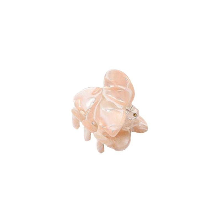 Die SOHO Hara Mini Hair Claw in Cloud Pink von SOHO ist ein kleines, glänzendes, elefantenförmiges Haaraccessoire, das einer Figur ähnelt und auf einem weißen Hintergrund präsentiert wird.