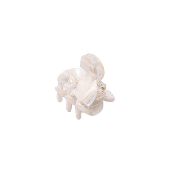 Die SOHO Hara Mini Hair Claw – Porcelain von SOHO ist ein kleines, transparentes Haaraccessoire aus Kunststoff, das einer Mini-Klammer ähnelt und vor einem weißen Hintergrund isoliert dargestellt ist.