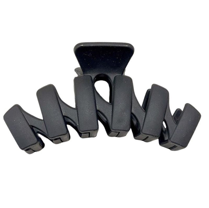 The SOHO Just Hair Claw - Black by SOHO features five wide, curved prongs for a secure hold and sleek style, making it the perfect accessory to keep your hair in place.