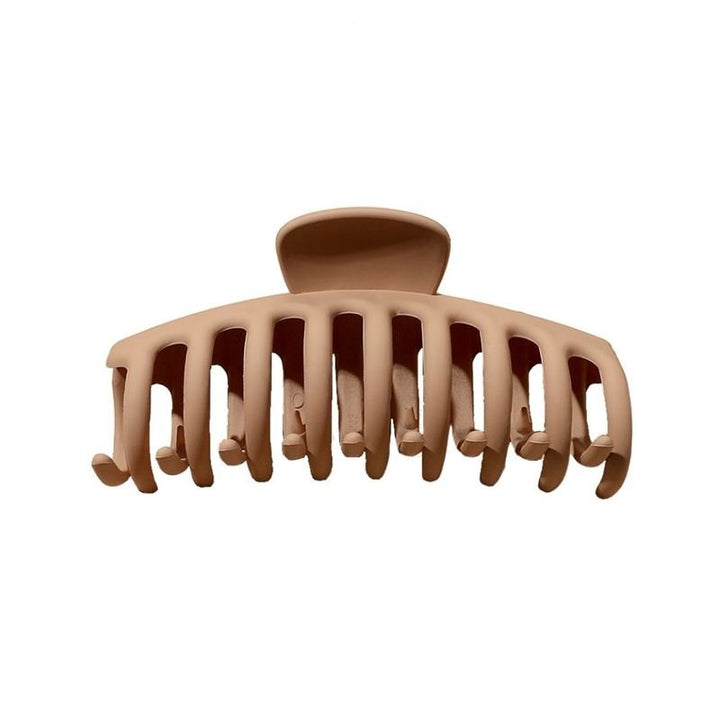 The SOHO Kana Hair Claw - Beige features wide, curved teeth for a strong grip on all hair types and is pictured against a white background.