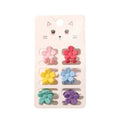 Die SOHO Lala Mini Hair Claws – Flowers von SOHO enthalten sechs bunte Mini-Haarklammern (rosa, rot, gelb, blau, türkis, lila) auf einer weißen Karte mit einer niedlichen Katzenillustration.