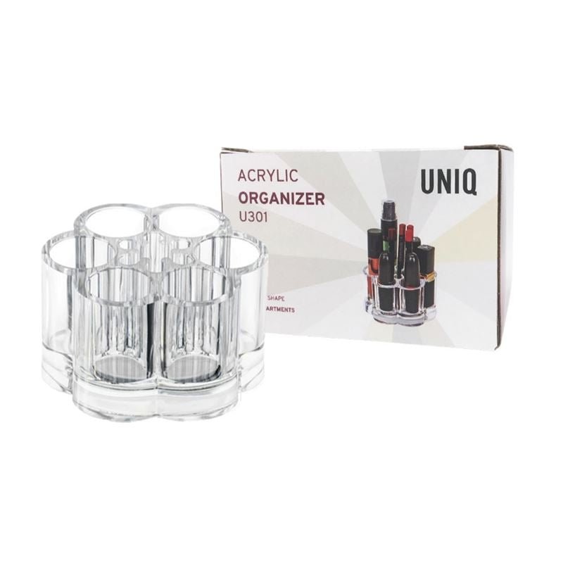 Der UNIQ Flower Makeup Acrylic Organiser – U301 von UNIQ wird neben seiner Verpackung gezeigt, auf der der Produktname und ein Bild des Organizers zu sehen sind, in dem Make-up-Artikel ordentlich in mehreren durchsichtigen Fächern aufbewahrt werden.